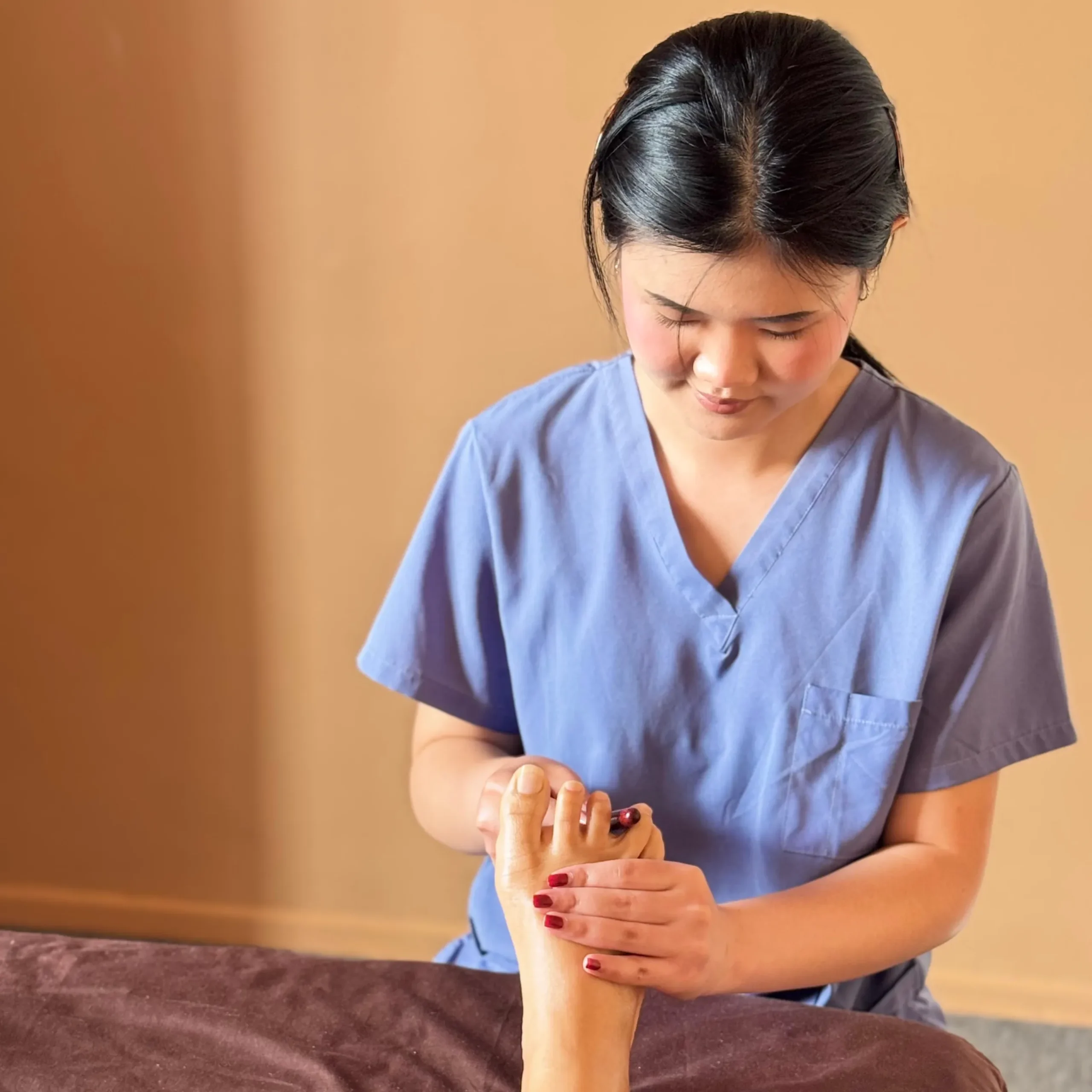 photo of kitty giving a reflexology massage to a client