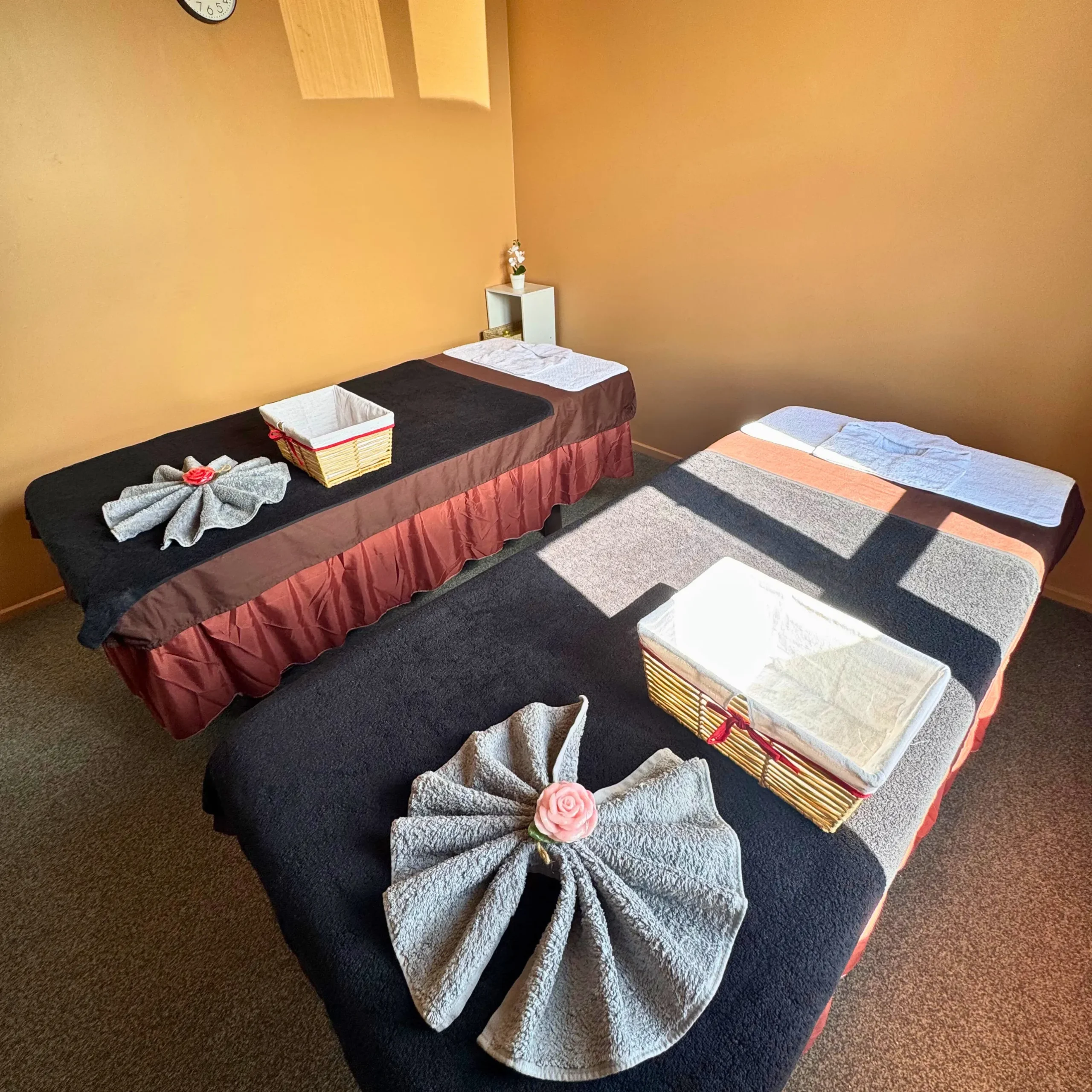 A photo of two massage tables at Sinapha Thai massage in devonport shot from the right corner next to the window